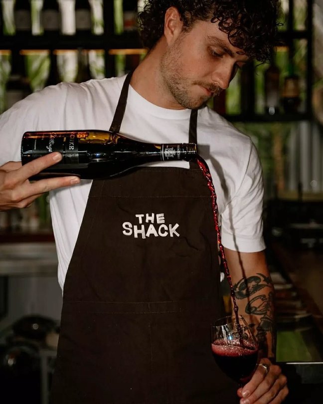 Bartender wearing a branded apron